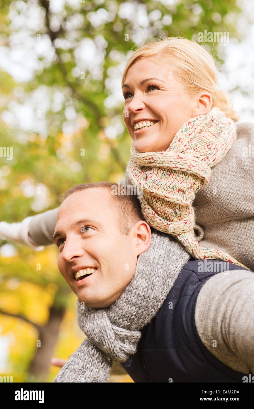 smiling couple having fun in autumn park Stock Photo - Alamy