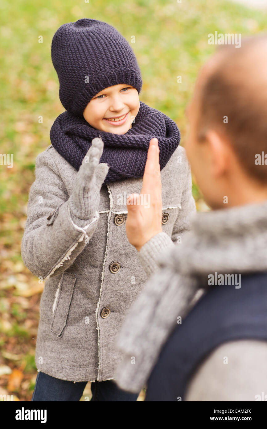 happy father and son making high five in park Stock Photo