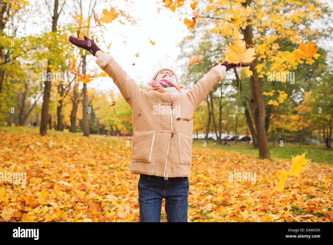 smiling little girl with autumn leaves in park Stock Photo - Alamy