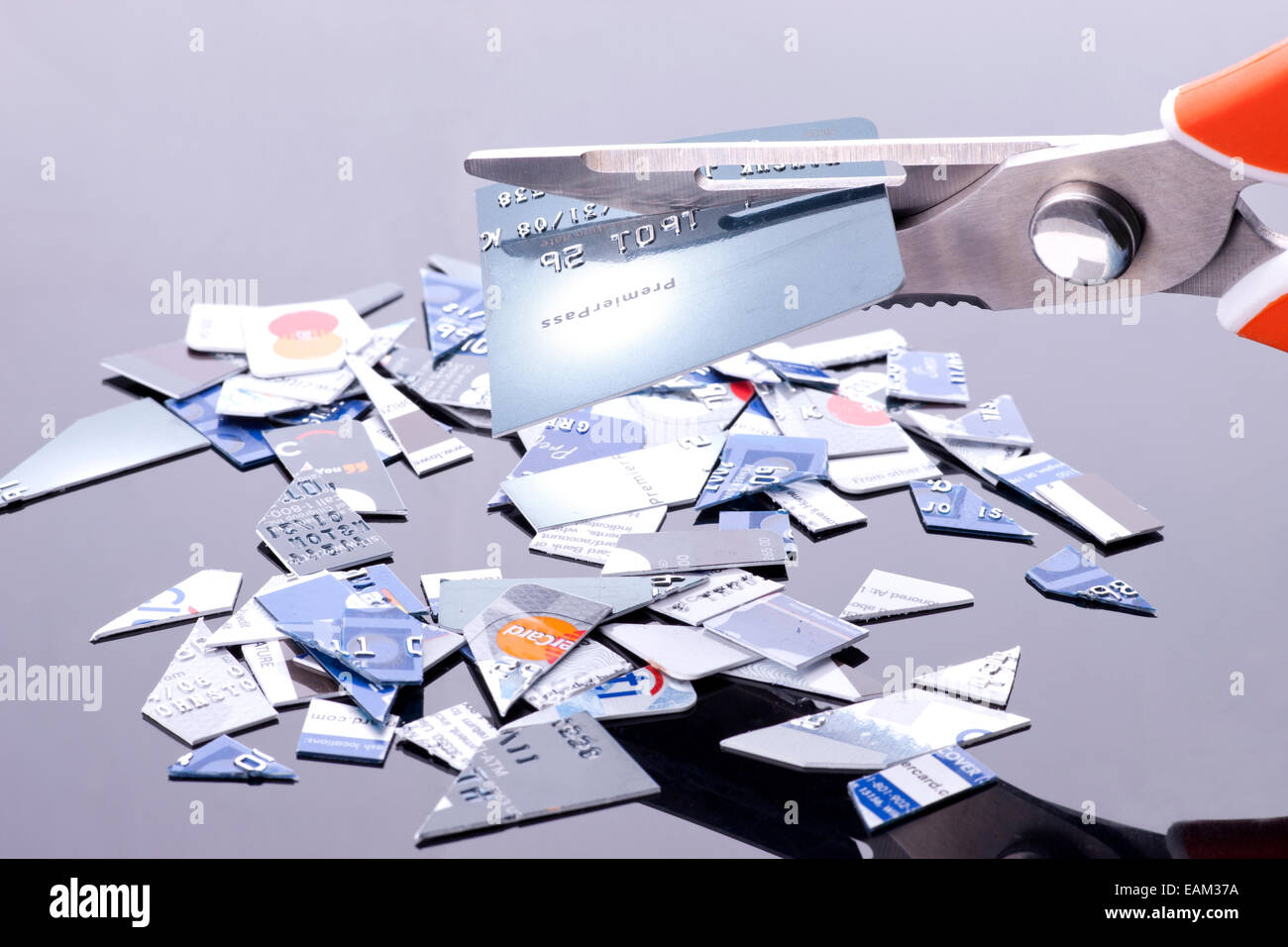 The act of cutting up credit cards for financial freedom. Stock Photo