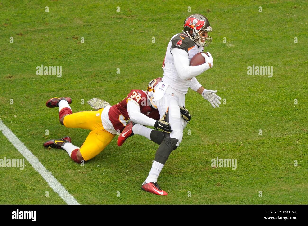 NOV 16, 2014 : Washington Redskins cornerback David Amerson (39) tackles Tampa Bay Buccaneers wide receiver Mike Evans (13) during the matchup between the Tampa Bay Buccaneers and the Washington Redskins at FedEx Field in Landover, MD. Stock Photo