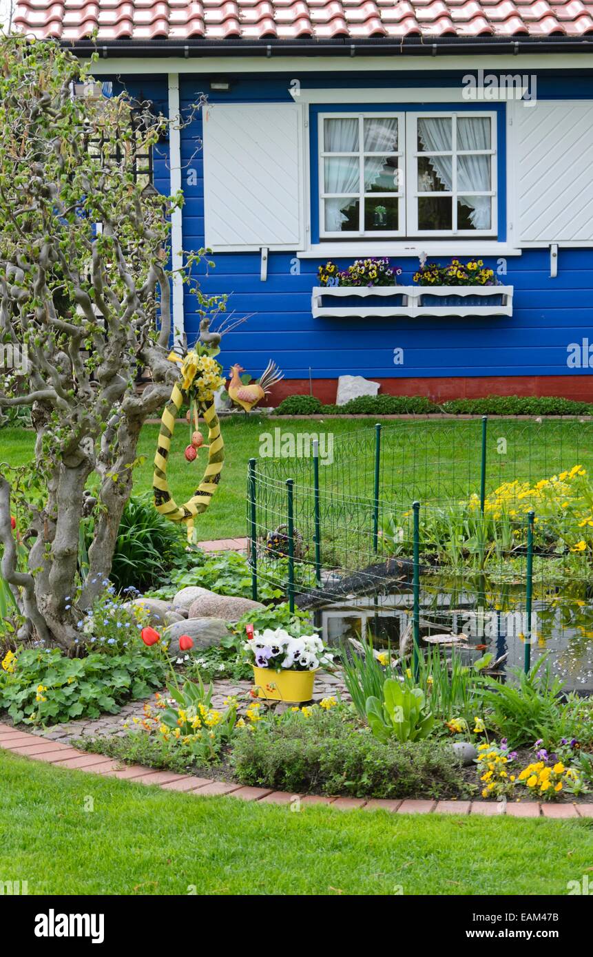 Allotment garden with blue garden house and garden pond Stock Photo