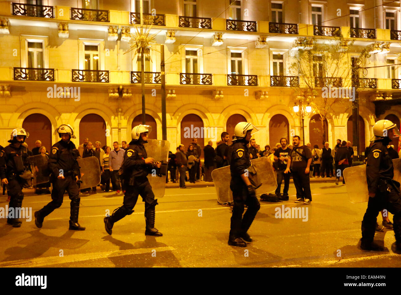 Police officers in full riot gear accompany the protest march ...