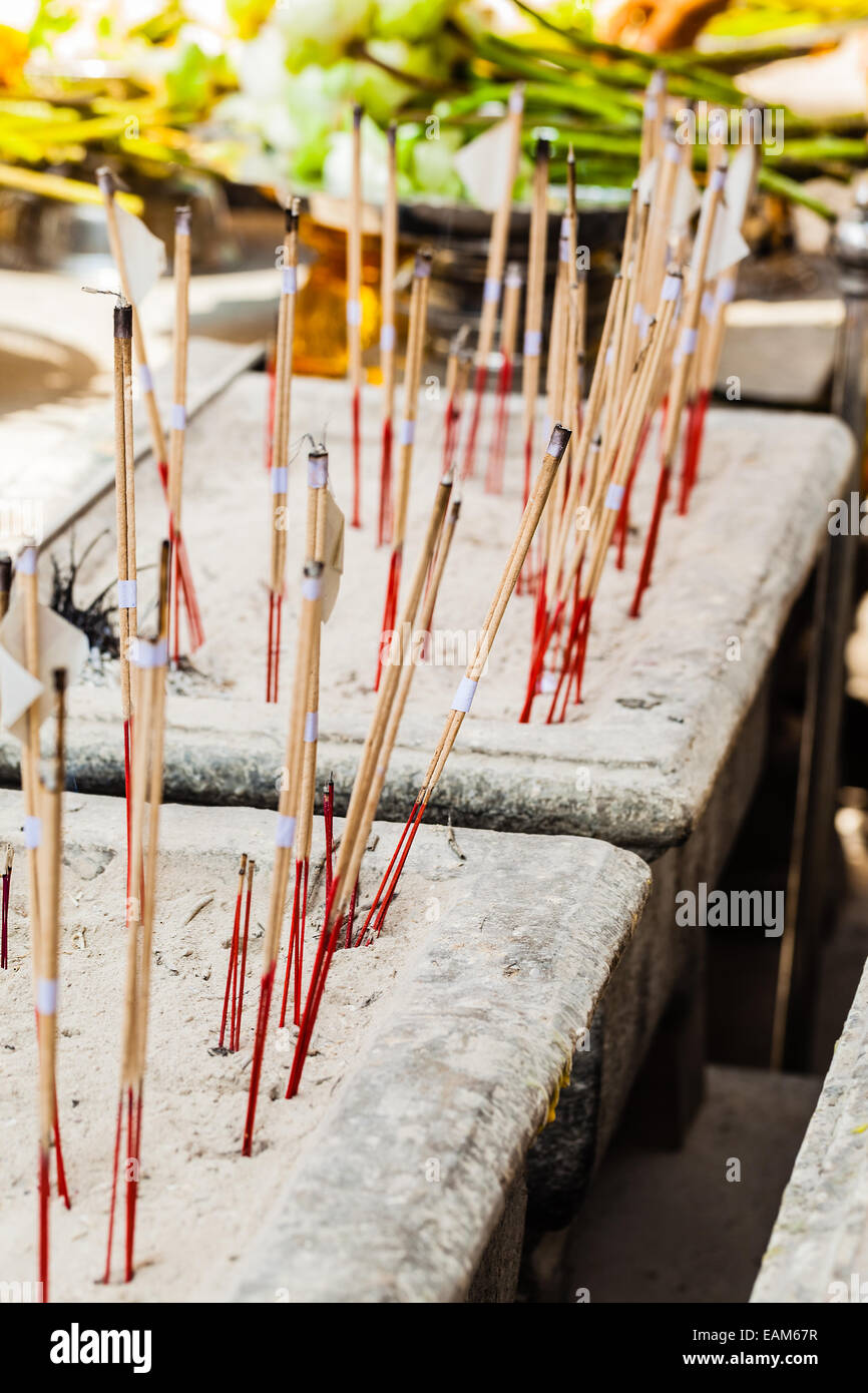 burning incense sticks in a buddhist temple in bangkok, thailand Stock