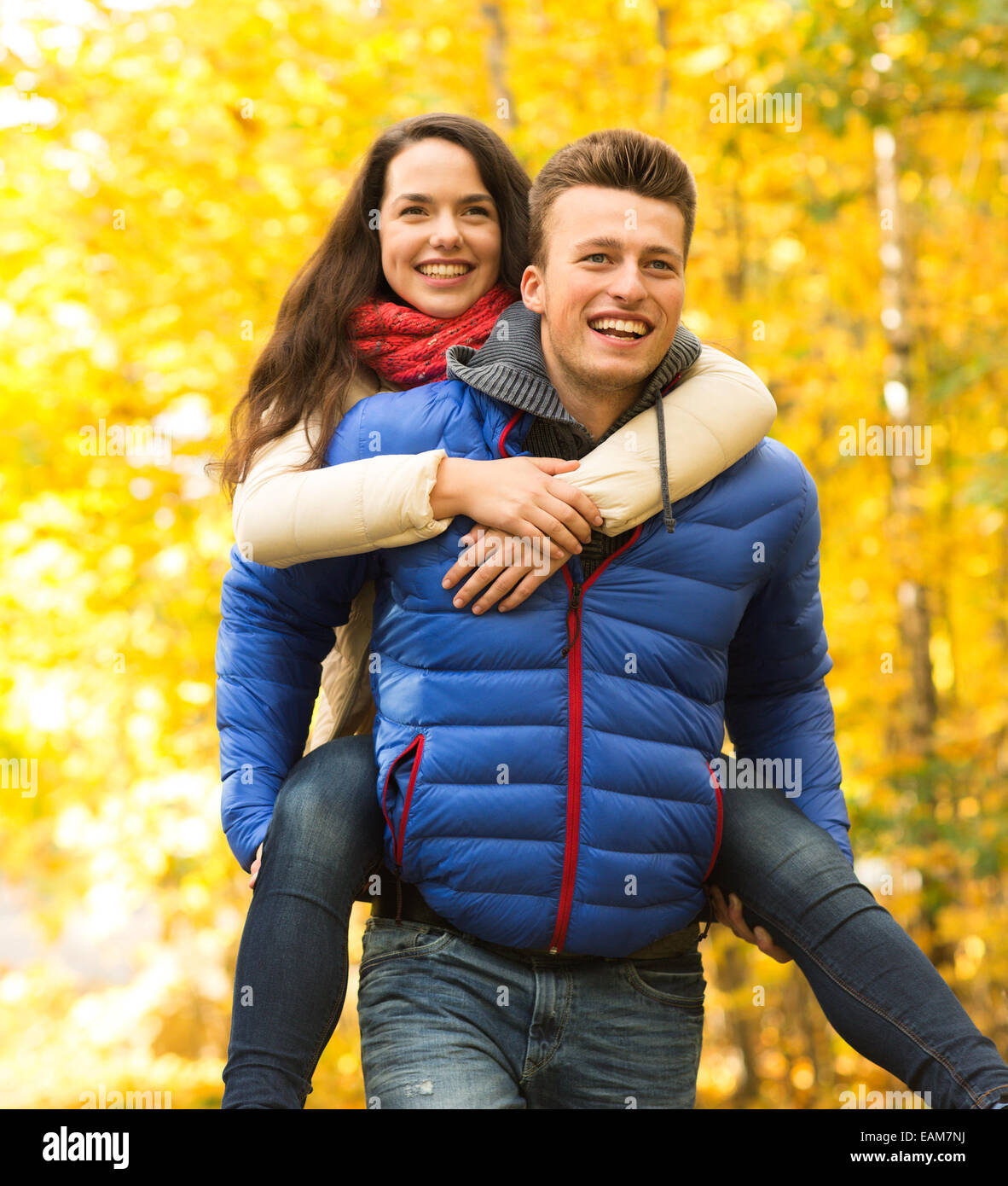smiling couple having fun in autumn park Stock Photo - Alamy