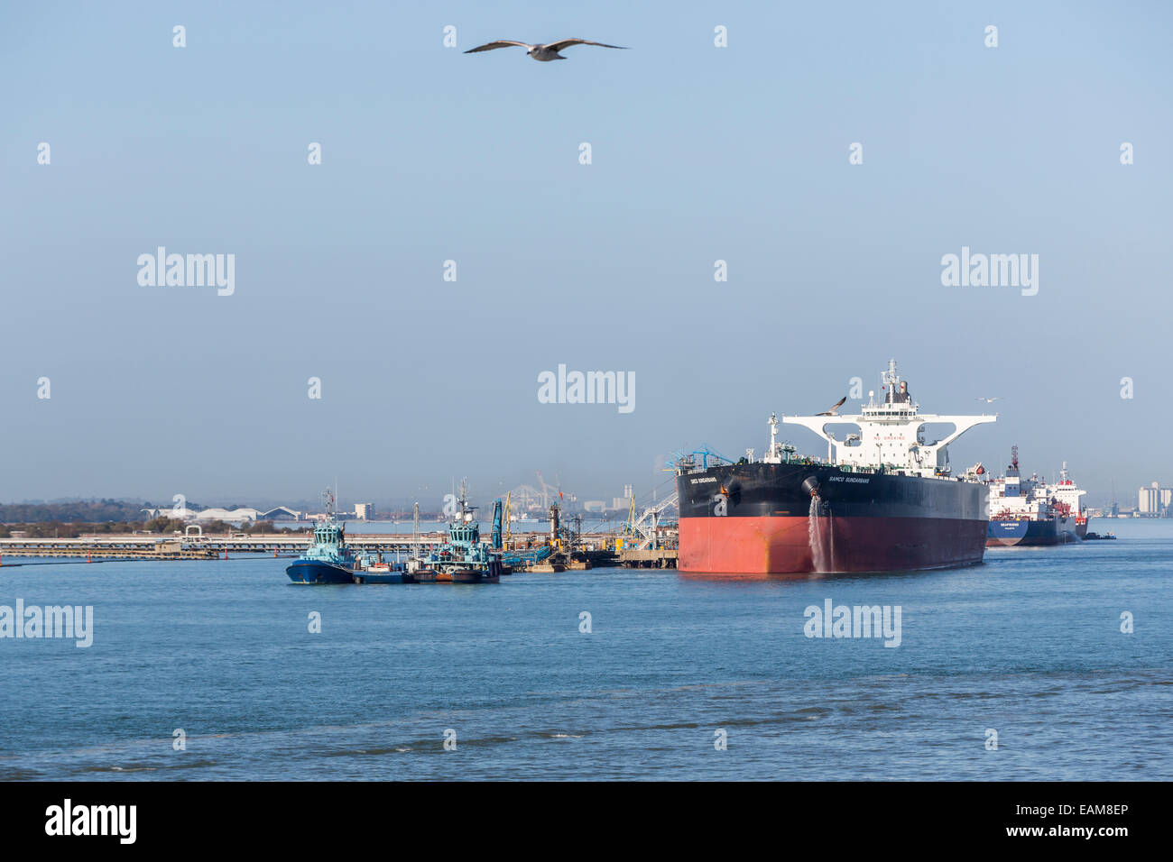 Oil tankers, including 'Samco Sunderbans', and tugs moored at the Exxon