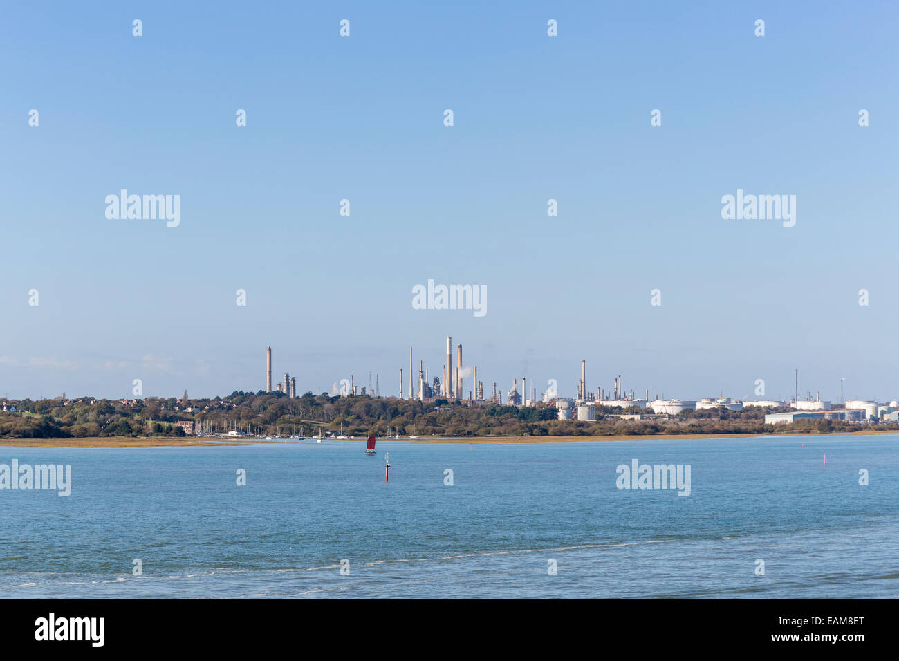 Exxon Mobil oil refinery with cooling towers, stacks and storage tanks on Southampton Water, the Solent at Fawley, Hampshire, UK Stock Photo