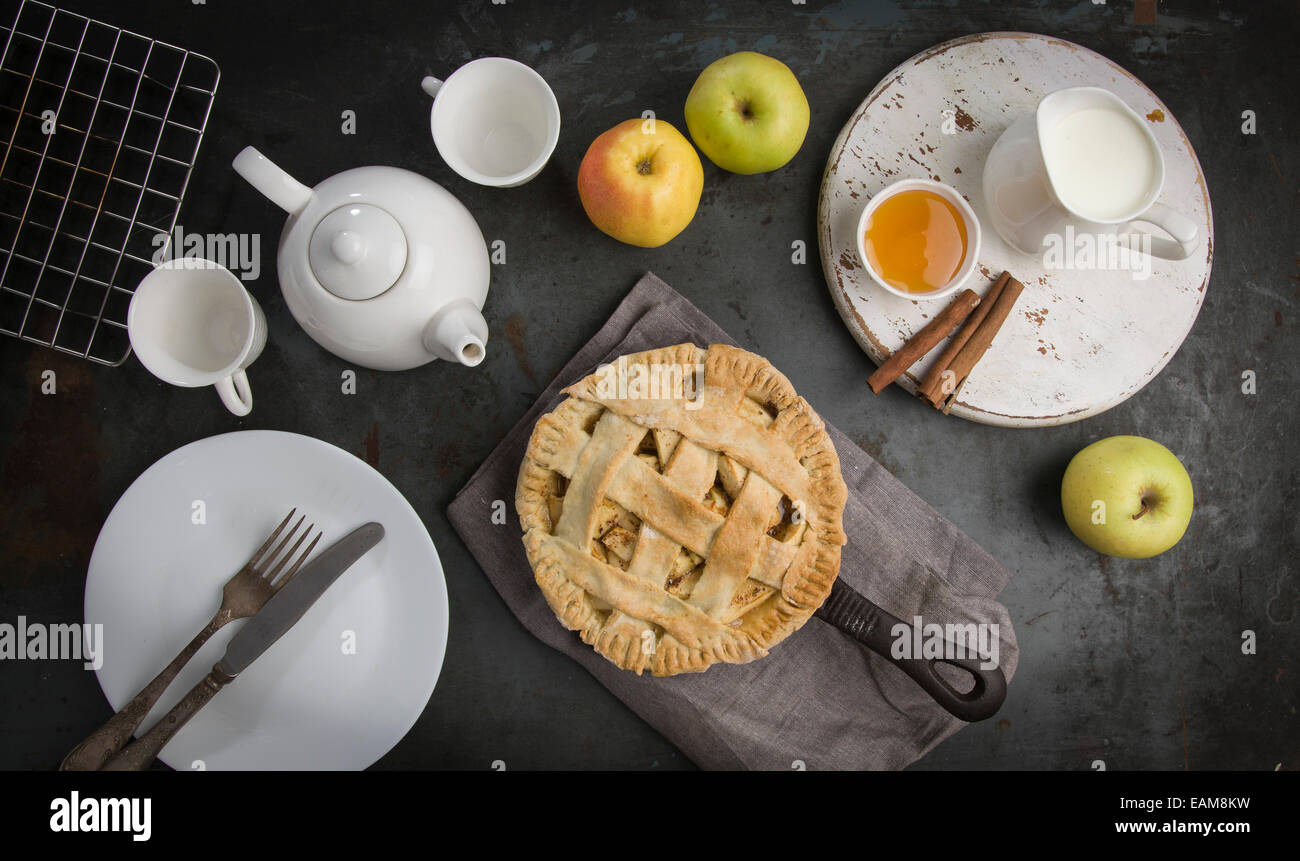 Apple Pie on iron skillet with tea and honey. Top view Stock Photo