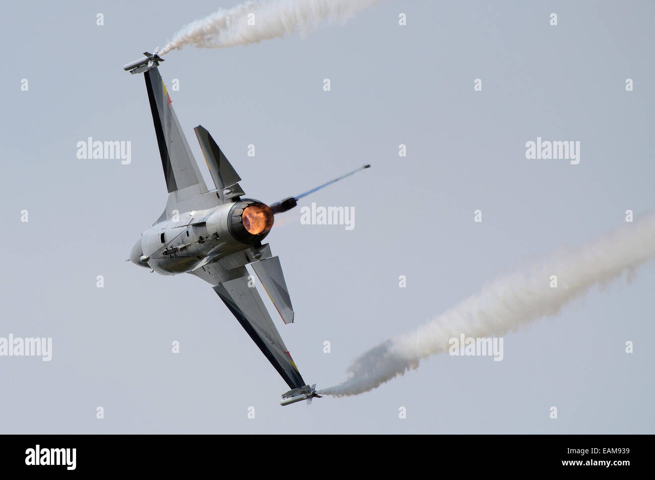 The F-16 Solo Display Team of the Belgian Air Force is based at Florennes Air Force base. Pulling hard with afterburner reheat and smoke Stock Photo