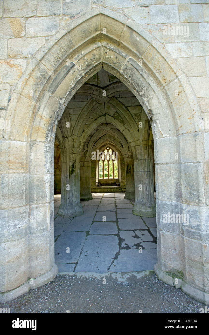Arched entrance leading to interior with vaulted ceiling of 13th century Valle Crusis abbey ruins near Llantysilio in Wales Stock Photo