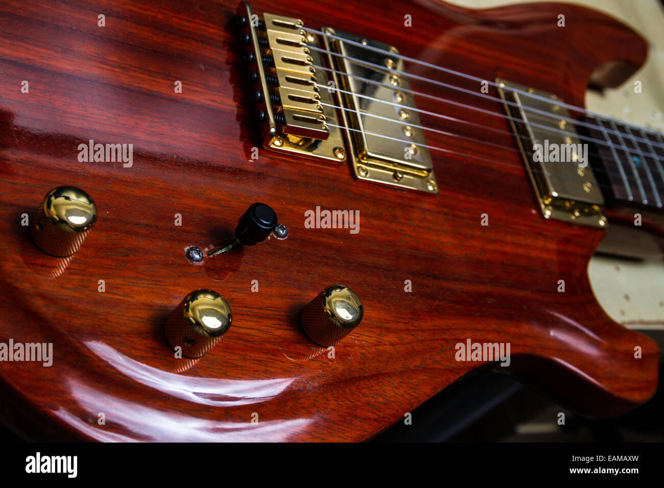A custom made Guitar from exotic wood Padouk with Gold hardware Stock Photo  - Alamy