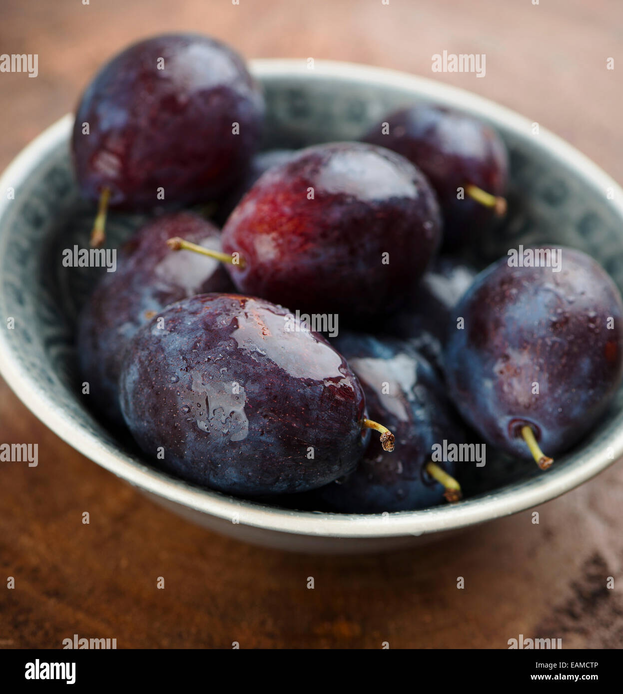 fresh plums in a bowl Stock Photo