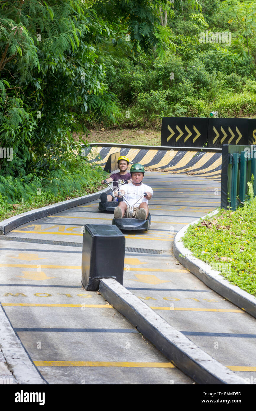 Young people riding luge at Sentosa Island Singapore Stock Photo