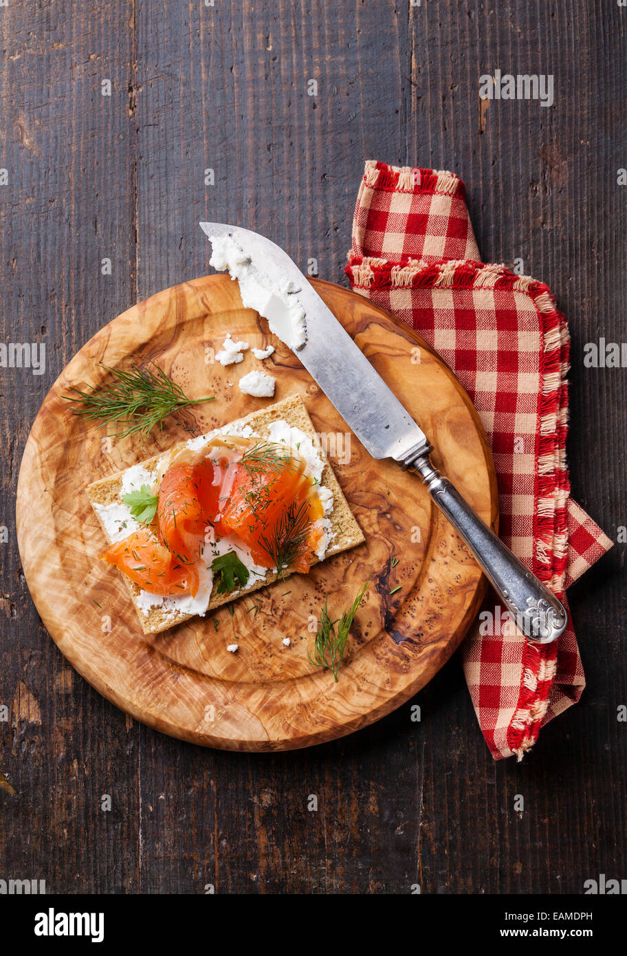 Sandwich on Crisp bread with Smoked salmon and soft Cream cheese on Olive wood plate Stock Photo