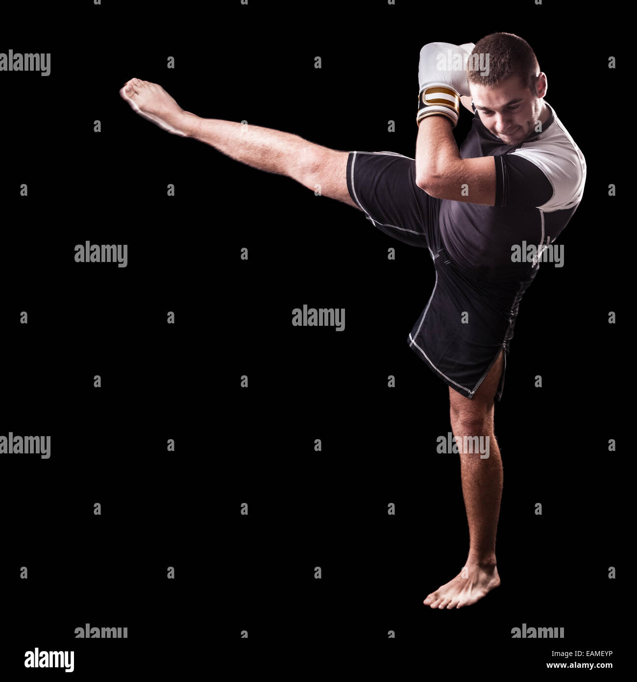 a young kickboxer or boxer isolated over a black background Stock Photo
