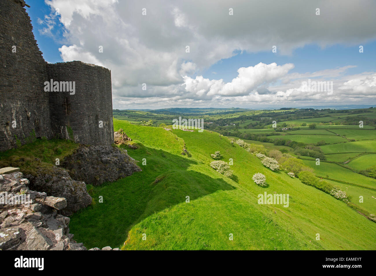 Spectacular view of vast emerald farmlands on rolling hills under blue sky from ruins of hilltop Carrig Cennen castle in Wales Stock Photo