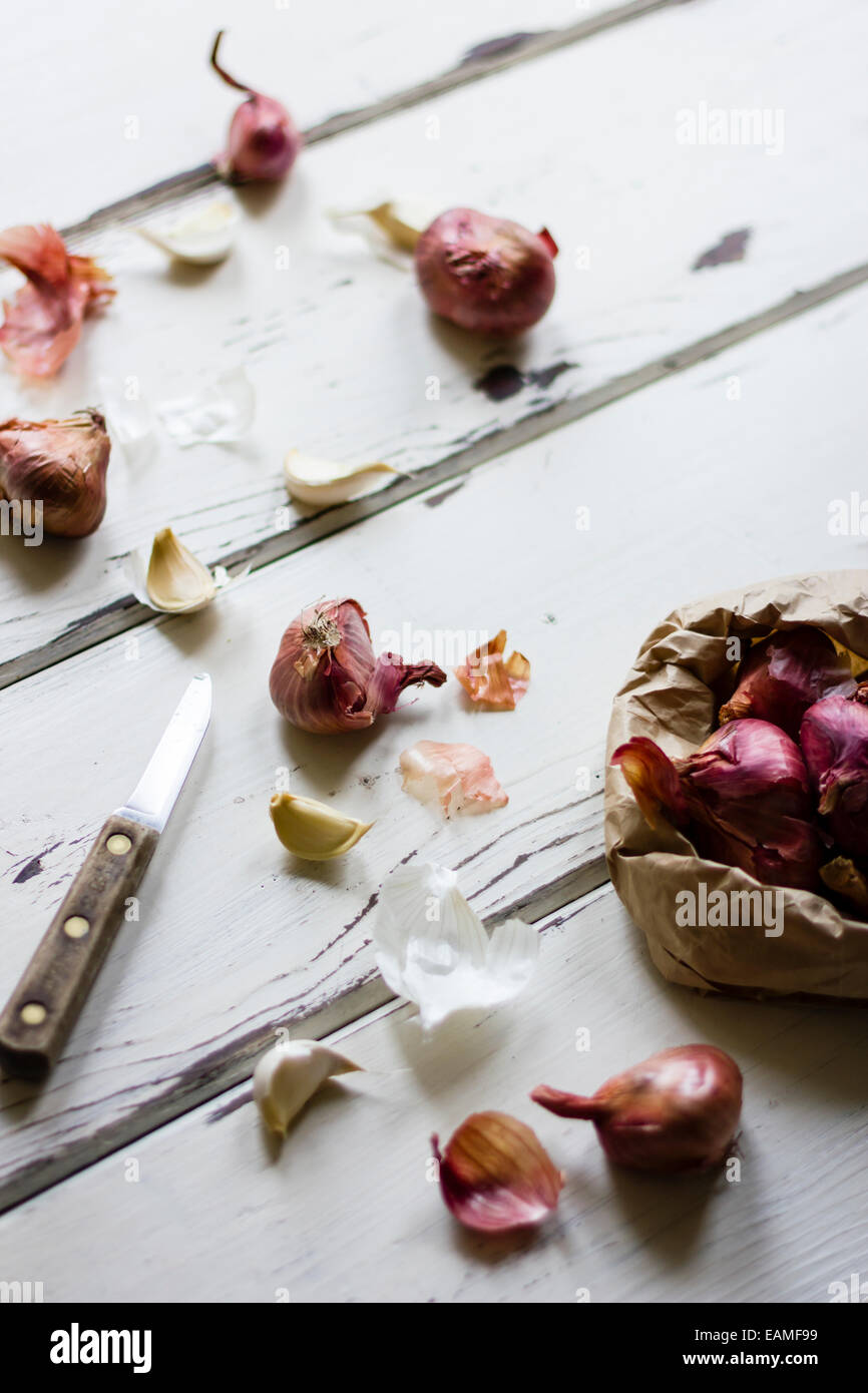 Shallots and Garlic, with Knife on White Wood Stock Photo