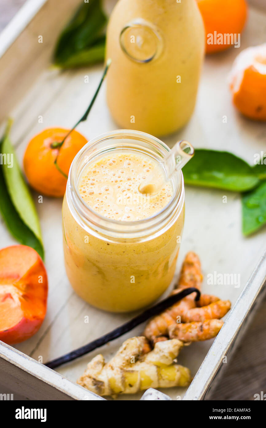 Winter Smoothies in Vintage Crate with Vanilla, Ginger, Turmeric, Tangerine and Persimmon Stock Photo