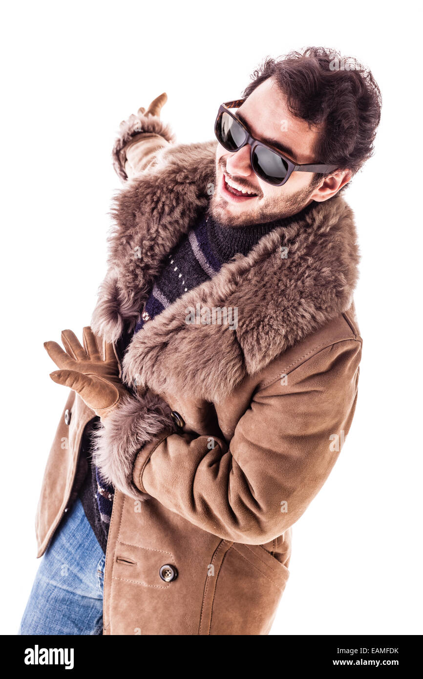a cheerful young man wearing an expensive sheepskin furry coat isolated