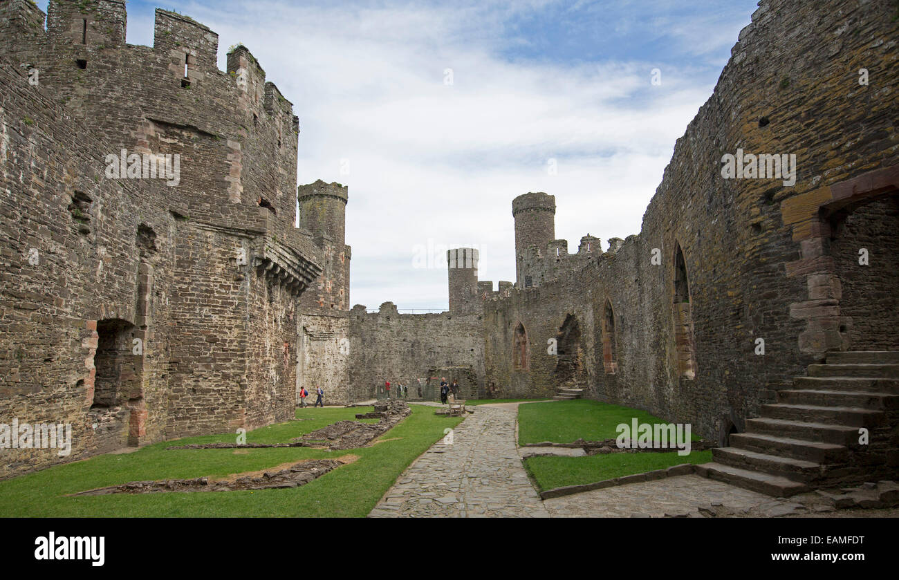 Interior of spectacular Conwy castle in Wales with relatively intact walls, towers & battlements around lg grassed courtyard Stock Photo