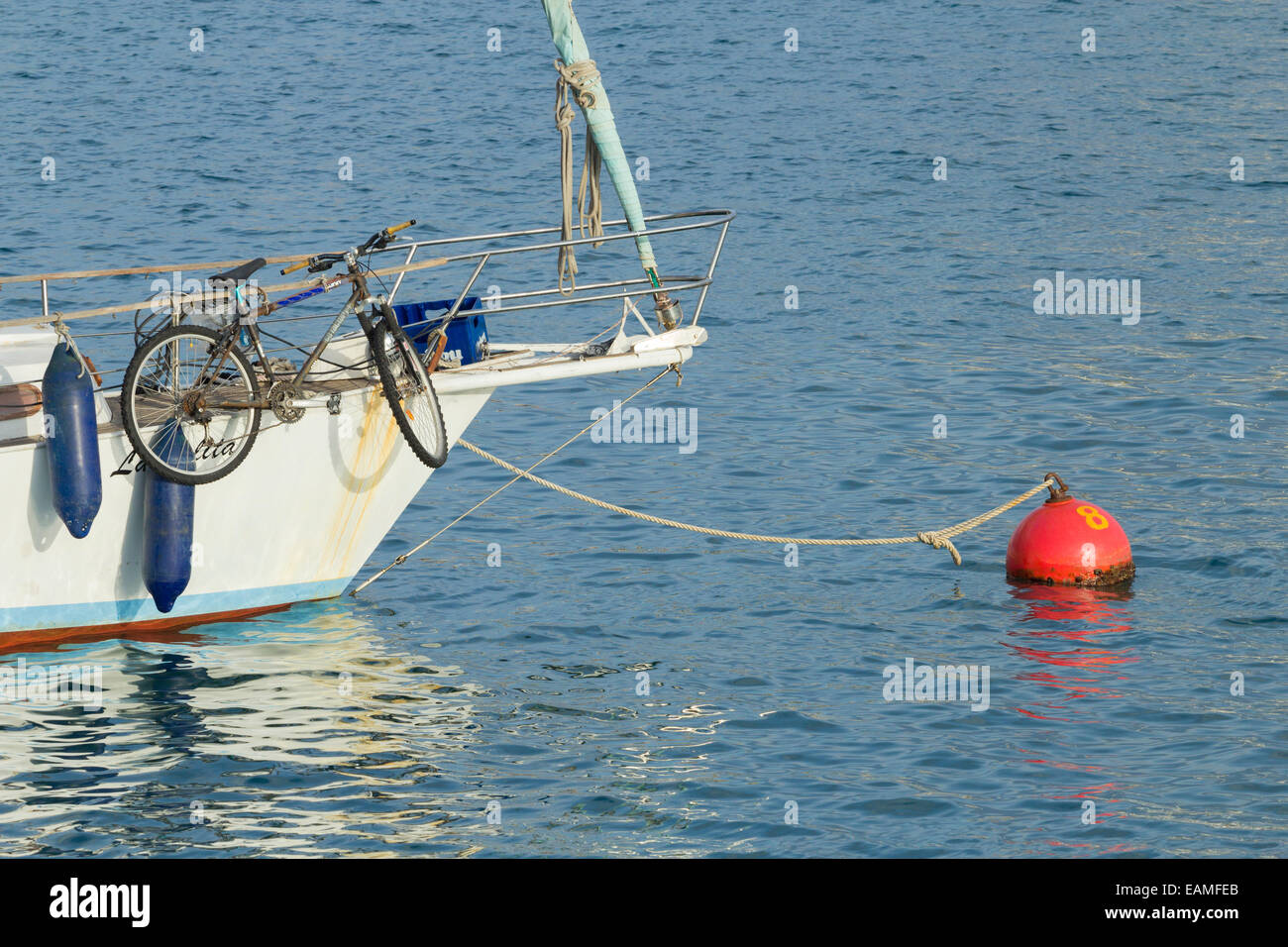 Mountain bike on bow of small yacht in Spain Stock Photo
