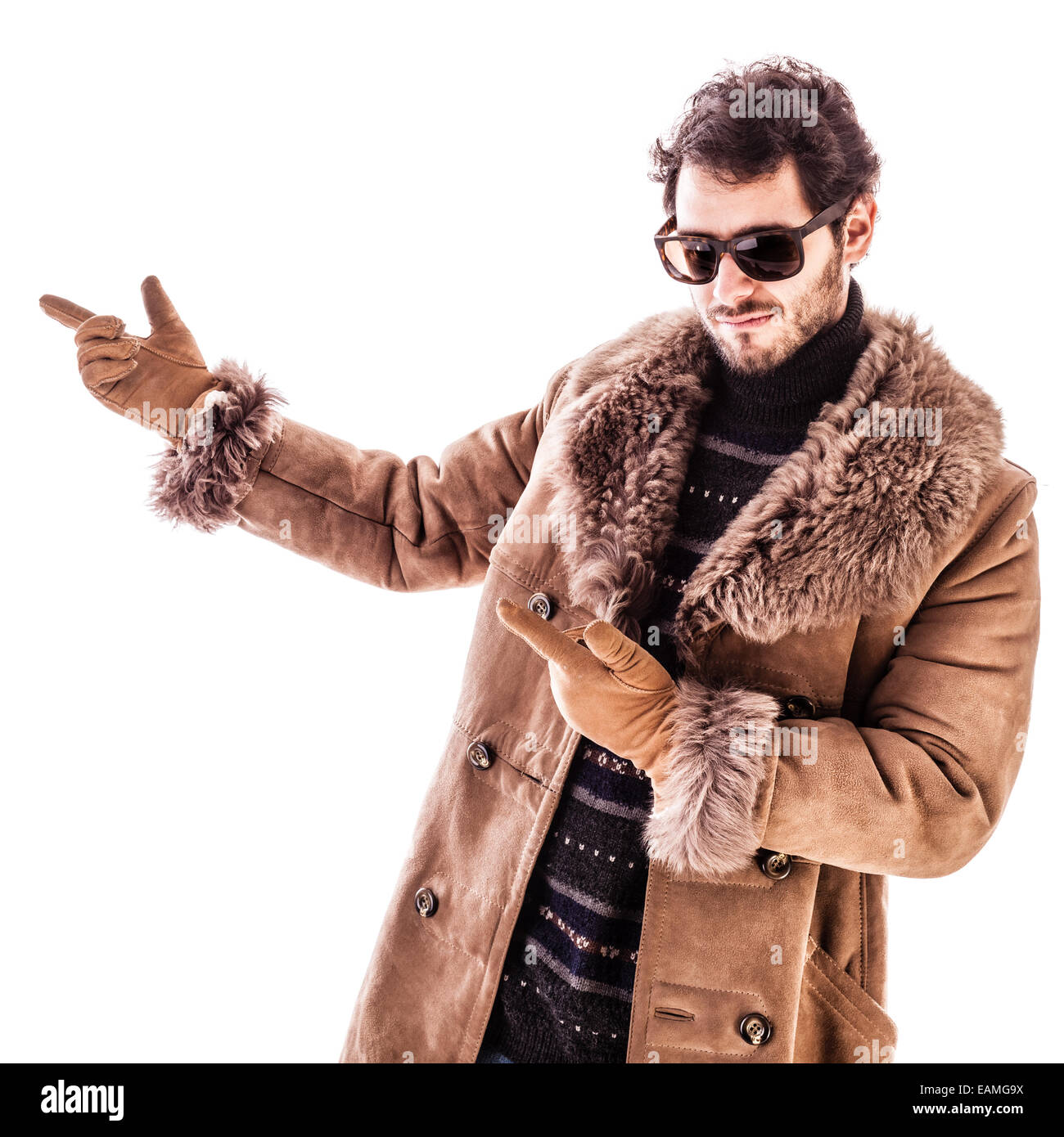 a young man wearing a sheepskin coat isolated over a white background ...