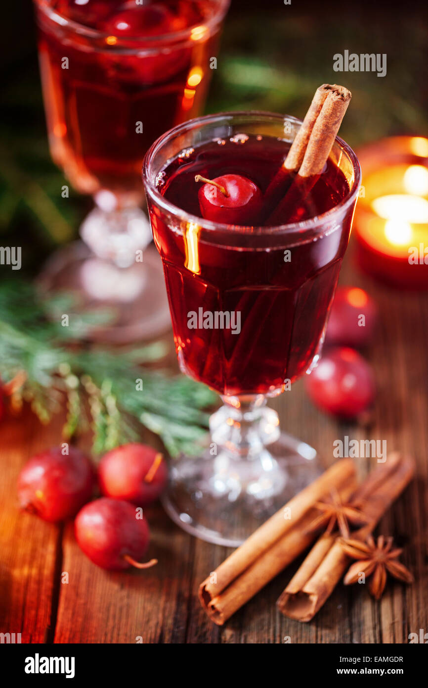 Hot mulled wine with small crab apples, cinnamon stick ans anise closeup Stock Photo