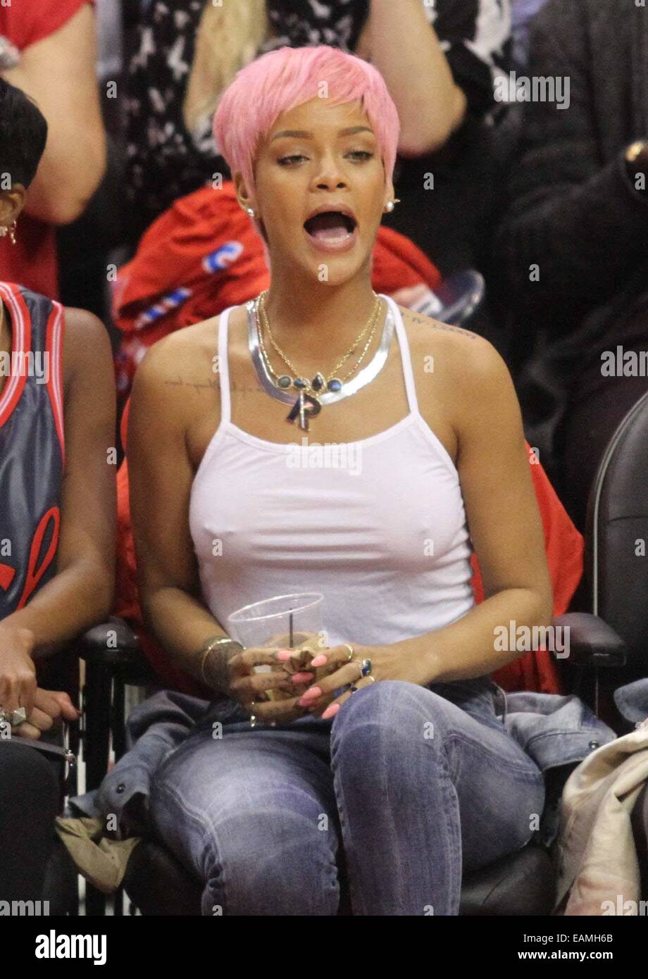 https://c8.alamy.com/comp/EAMH6B/rihanna-sports-a-new-pink-hairstyle-as-she-and-a-friend-cheer-on-the-EAMH6B.jpg