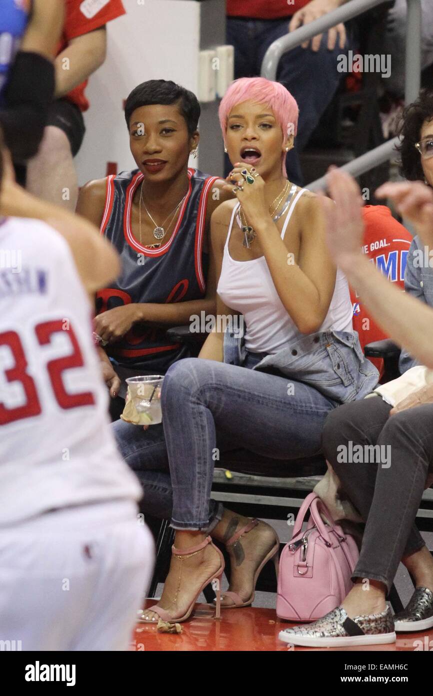 Rihanna sports a new pink hairstyle as she and a friend cheer on the Los  Angeles Clippers NBA basketball game against The Oklahoma City Thunder. The  Thunder defeated the Clippers by the