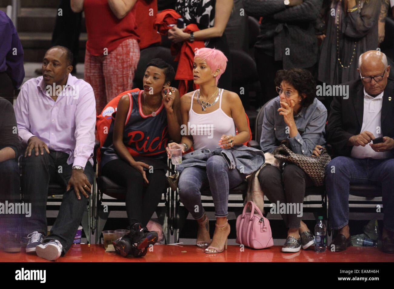 Rihanna sports a new pink hairstyle as she and a friend cheer on the Los  Angeles Clippers NBA basketball game against The Oklahoma City Thunder. The  Thunder defeated the Clippers by the