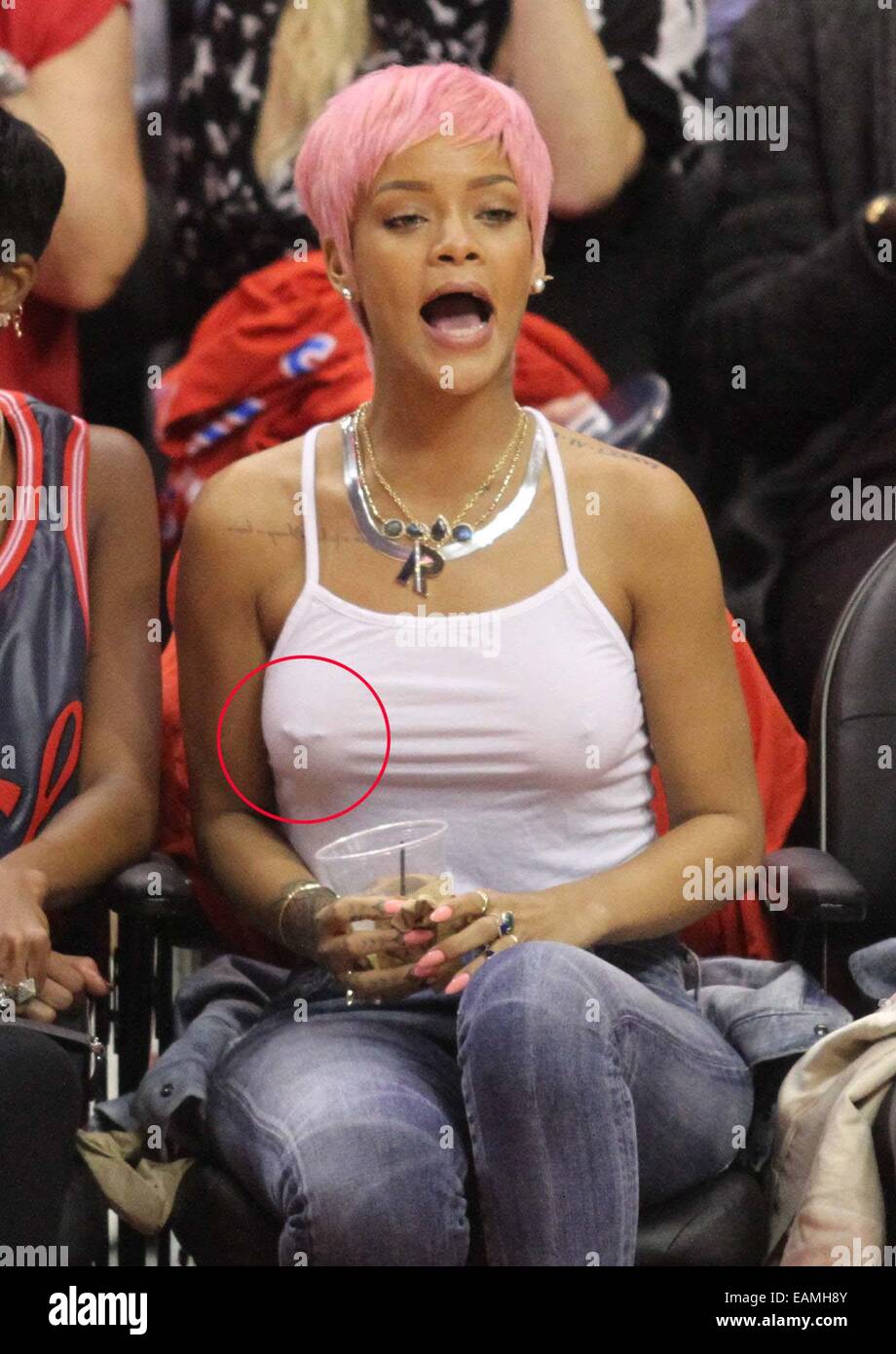 Rihanna's nipple ring can be seen beneath her vest at the Los Angeles  Clippers NBA basketball game against The Oklahoma City Thunder. The Thunder  defeated the Clippers by the final score of