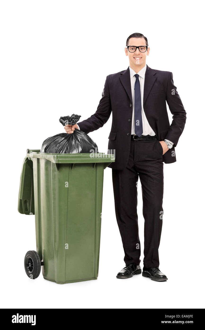 Full length portrait of a young businessman taking out the trash isolated on white background Stock Photo