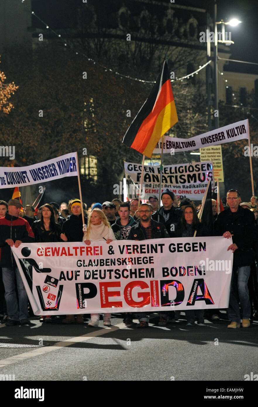 Dresden, Germany. 17th Nov, 2014. People march with a banner reading 'nonviolent and united against religious wars on German soil! Pegida' during a protest of right-wing initiative PEGIDA ('Patriotische Europaeer gegen die Islamisierung des Abendlandes', lit: 'Patriotic Europeans against Islamization of the Occident') in Dresden, Germany, 17 November 2014. PEGIDA claims to be against religious fanatism in any form, left-wing initiatives say the PEGIDA is promoting a hatred towards Islam and asylum seekers. Photo: MATTHIAS HIEKEL/dpa/Alamy Live News Stock Photo