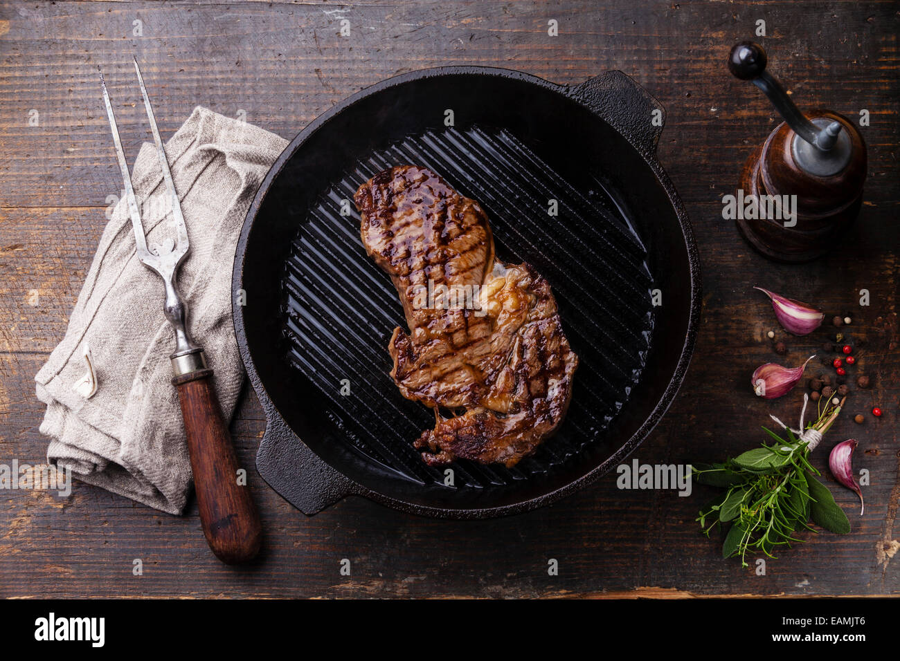 Grilled Ribeye steak entrecote on grill pan on wooden background Stock Photo