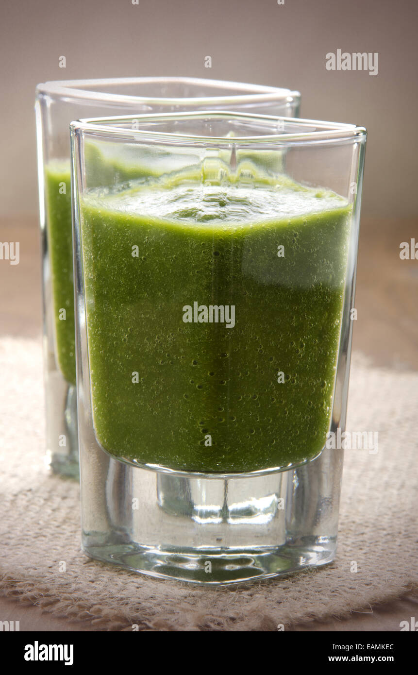 green smoothie made from celery, cabbage and bananas on jute in a shot glass Stock Photo