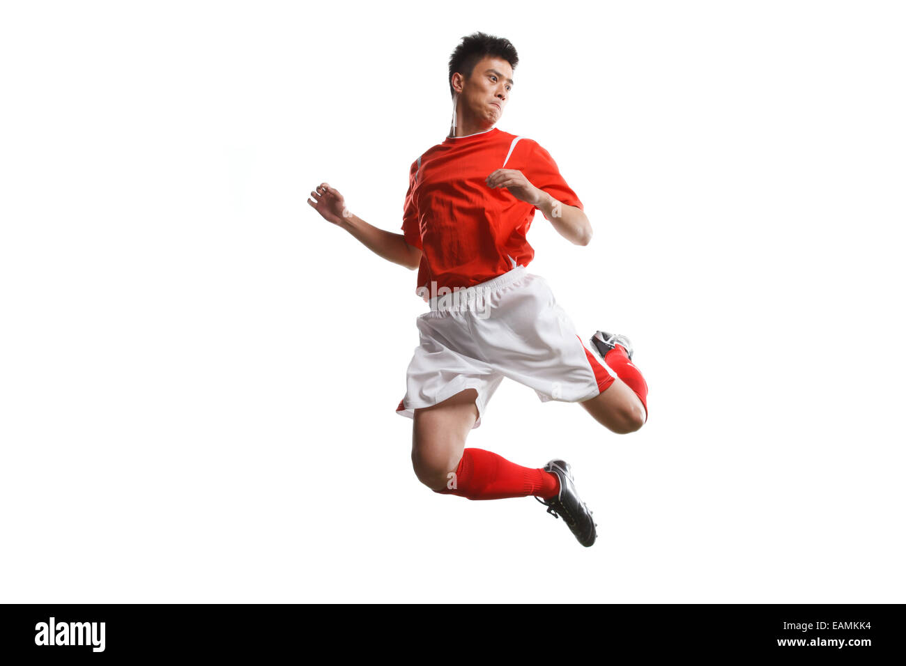 Football players jumping to play in midair Stock Photo