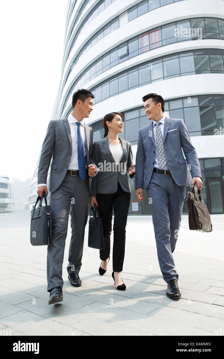 Eastern business people talk on the way to work Stock Photo