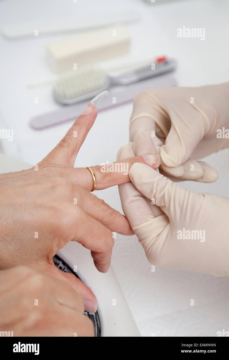 Manicure process on female hand, French manicure, Making nail extension Stock Photo Alamy