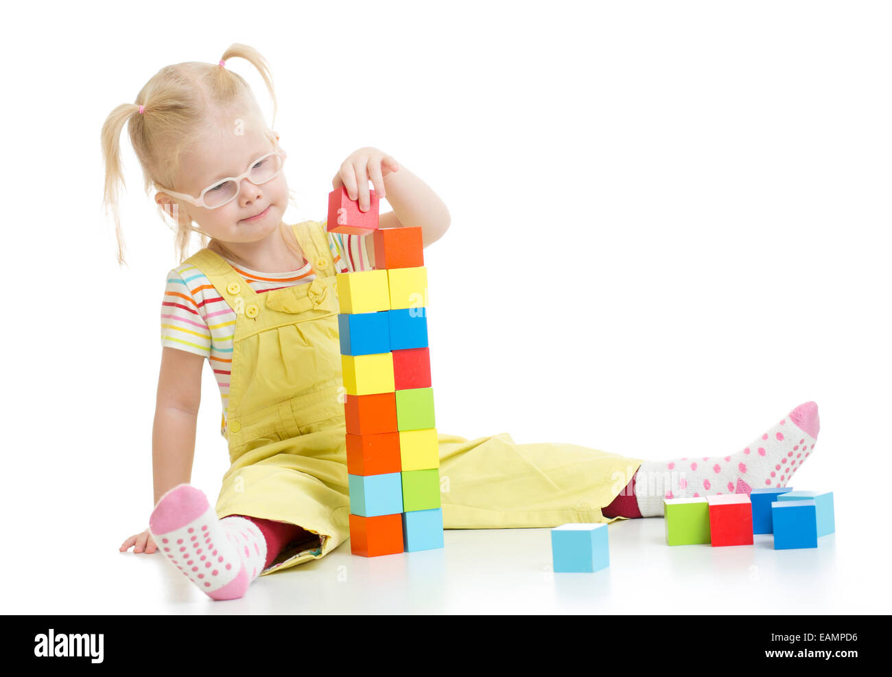 Child in eyeglases playing building blocks isolated Stock Photo