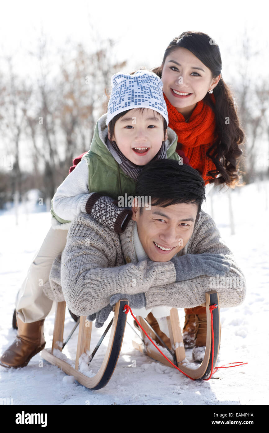 One-child families prone on the sled Stock Photo