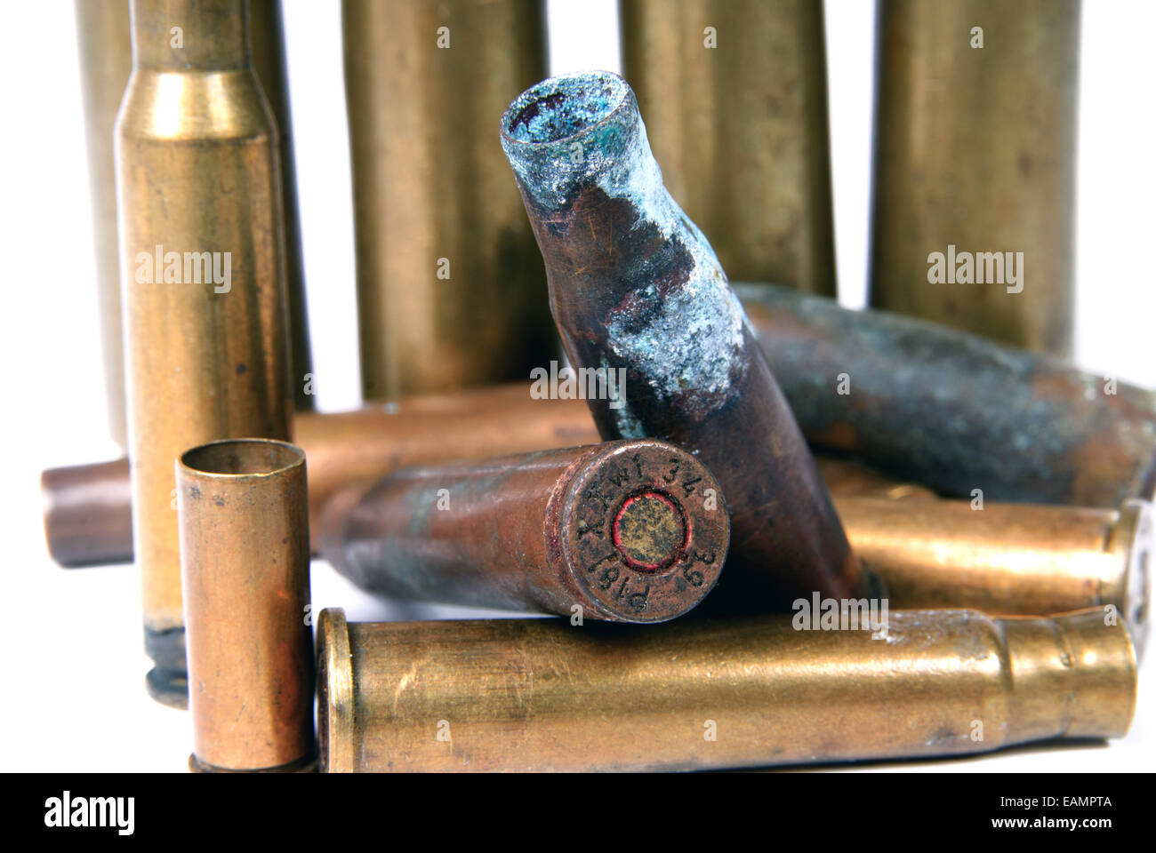 several shotgun shells in poor condition on white Stock Photo