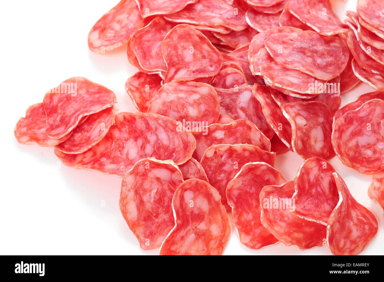 closeup of some slices of fuet, spanish cured sausage typical of Catalonia, on a white background Stock Photo
