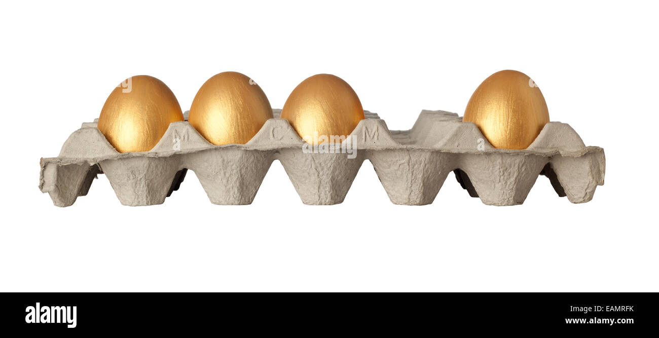 One golden egg missing from a tray of golden eggs isolated on white background Stock Photo