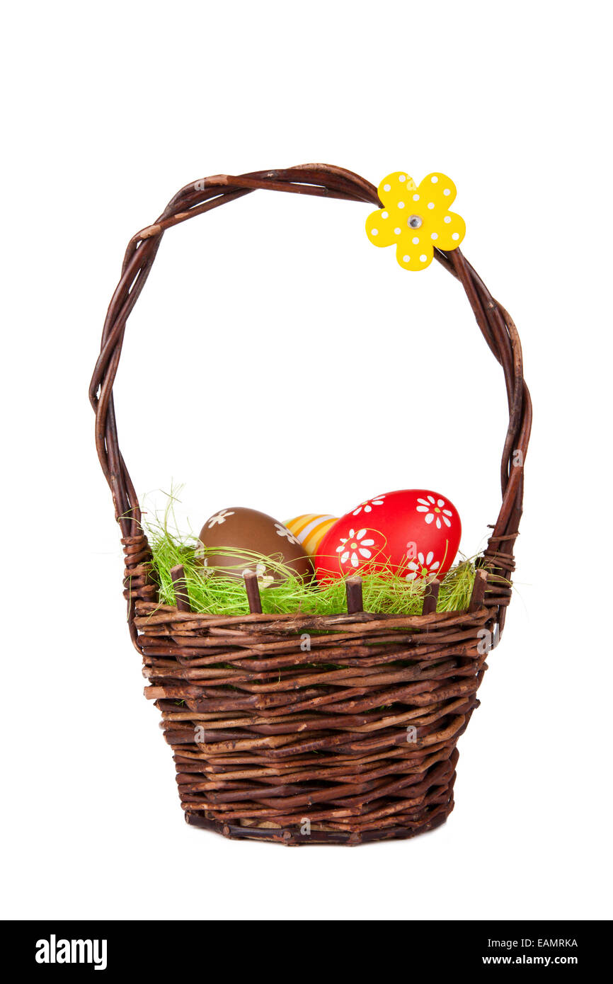 Easter basket with colored eggs, isolated on white background Stock Photo
