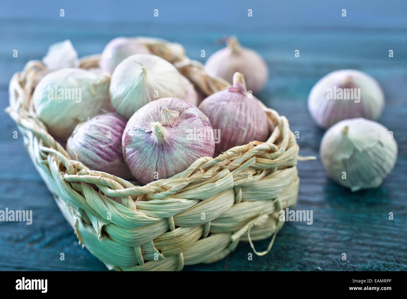 garlic in basket and on a table Stock Photo - Alamy