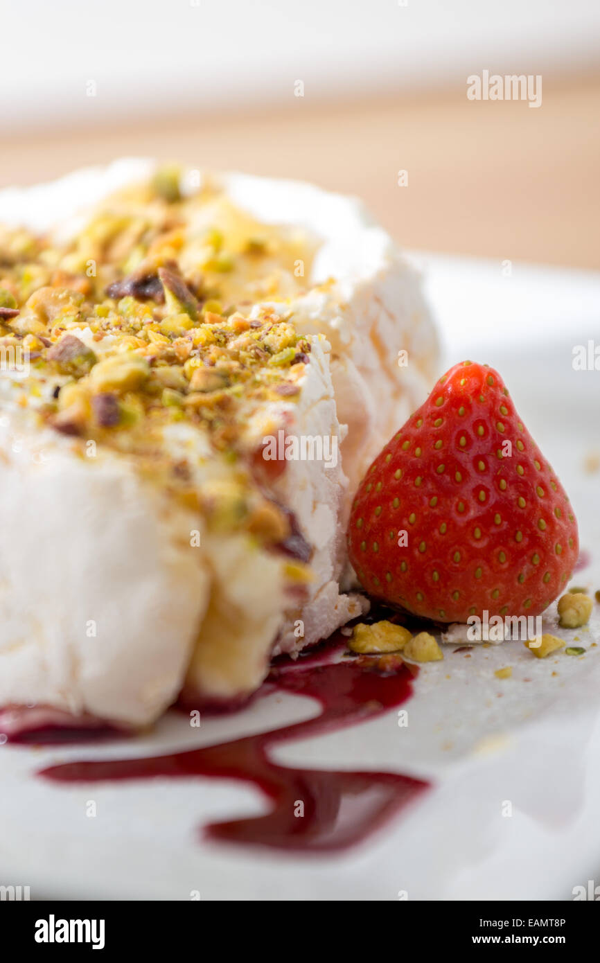 Meringue roulade with pistachio and raspberry coulis Stock Photo Alamy