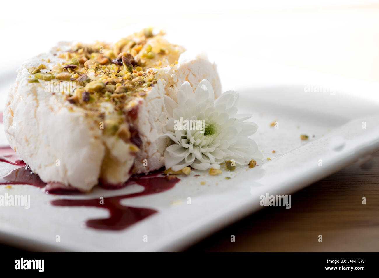 Meringue roulade with pistachio and raspberry coulis Stock Photo Alamy