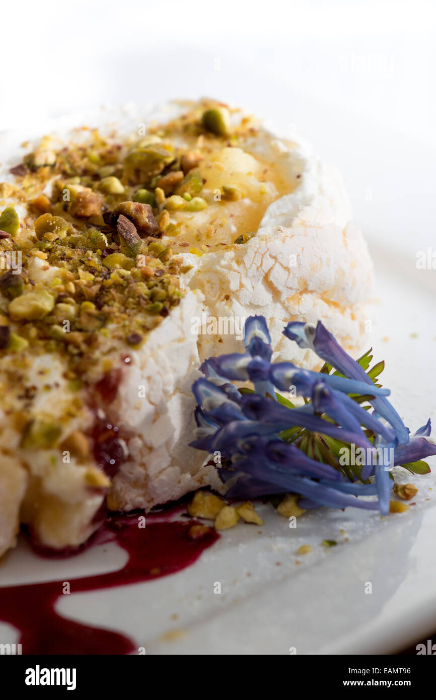 Meringue roulade with pistachio and raspberry coulis Stock Photo Alamy