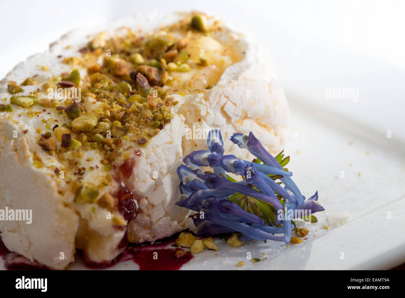 Meringue roulade with pistachio and raspberry coulis Stock Photo Alamy