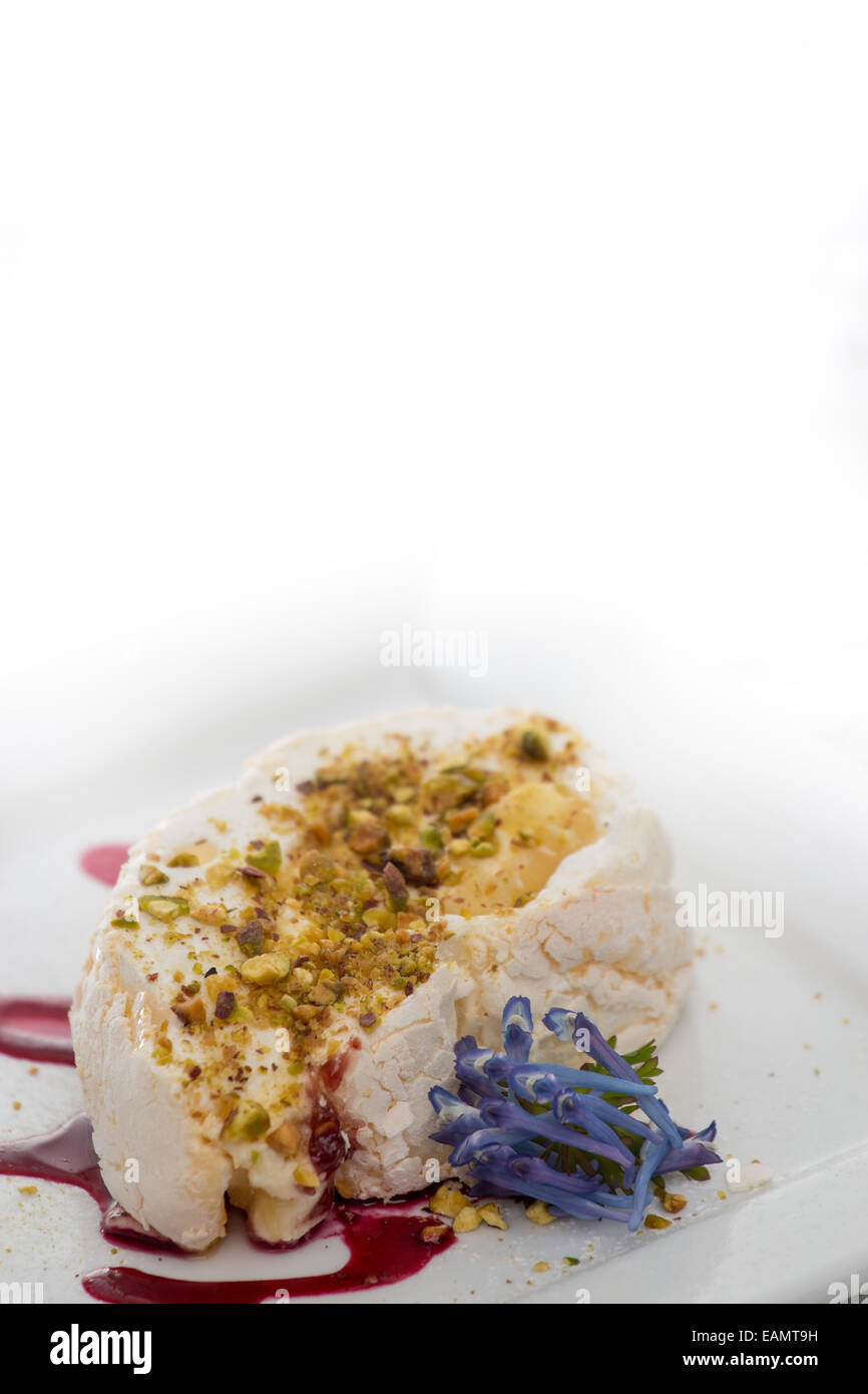 Meringue roulade with pistachio and raspberry coulis Stock Photo Alamy